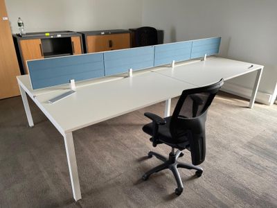 a white desk with a blue divider and a black chair