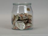 a glass jar filled with a lot of coins