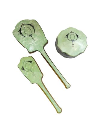 three paddles and a bowl on a white surface