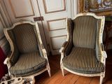 two chairs sitting next to each other on a hard wood floor