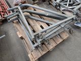 a pile of metal pipes on a pallet in a warehouse