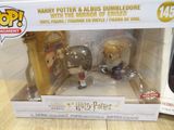 two harry potter and dumbble toys in a box on a table