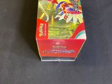 a box of pokemon cards on a table next to a ruler