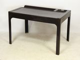 a small black table with a glass top on a white floor