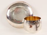silverplated cup and saucer on a white background