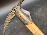 a close up of a hammer with a wooden handle on a table