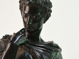 a bronze statue of a man with a shaw around his neck