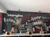 a picture of a restaurant with a chalkboard wall behind it