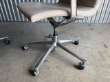 an image of an office chair with wheels in front of a corrugated wall