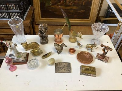 a white table with a lot of glass items on it
