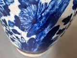 a blue and white vase sitting on top of a table