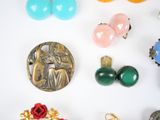 many different types of jewelry on a white surface