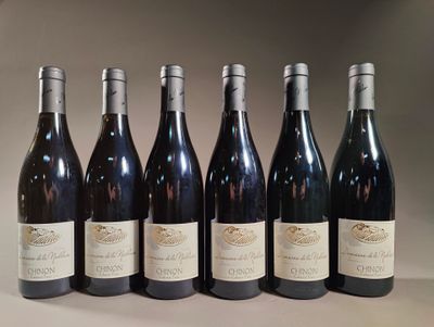 six bottles of wine are lined up in a row on a table