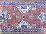 rug on the floor is red and blue with a pattern on it