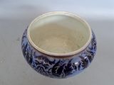 a blue and white vase sitting on a table