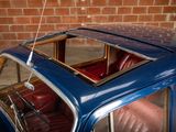 a blue car with red leather seats in a garage