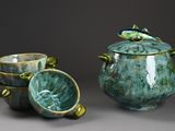 two bowls and a cup sitting next to each other