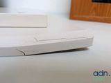 a white mouse sitting on a table next to a box