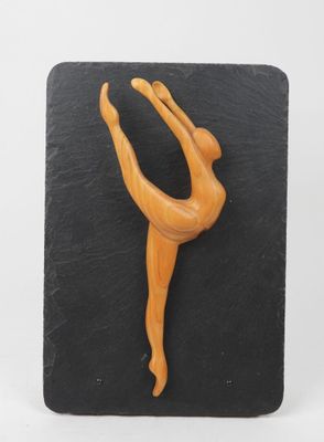 a close up of a figurine of a woman on a black plate