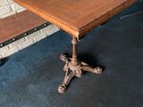 a wooden table with a metal base and a wooden bench