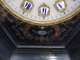 a close up of a clock with a gold and blue face