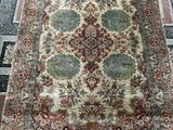 a large oriental rug with a floral design on a black and white floor