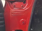 a close up of a door handle on a red car