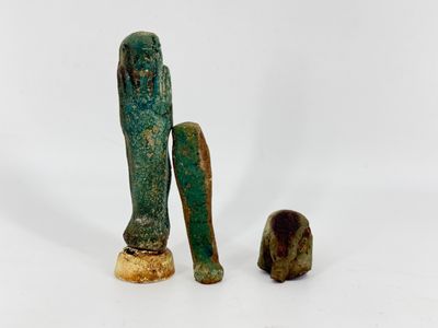 two ancient bronze figurines of a man and a dog