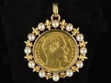 an image of a gold coin with pearls in the center