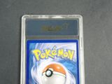 the pokemon trading card is in a plastic holder on a table
