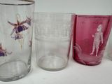 three glasses sitting on a table next to each other