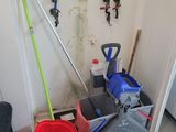 a mop and bucket in the corner of a room