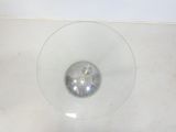 a glass bowl with a silver object inside of it