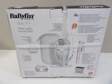 packaging of a babylis electric bottle warmerer with instructions on it