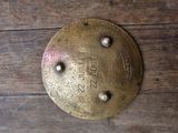 a brass plate on a wooden table with a name on it