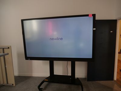 a large flat screen tv sitting on a stand in a room