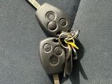 two keys attached to the back of a car seat