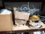 a box of wires and wires on a shelf in a room