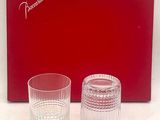 two glasses sitting next to each other in front of a red box