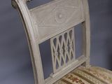 a white chair with a striped seat and back