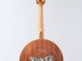 a guitar hanging from a string with a butterfly painted on it