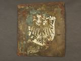 a picture of a piece of metal with a bird on it