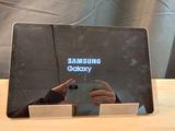 a person taking a picture of a samsung tablet