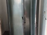 a metal locker in the corner of a room