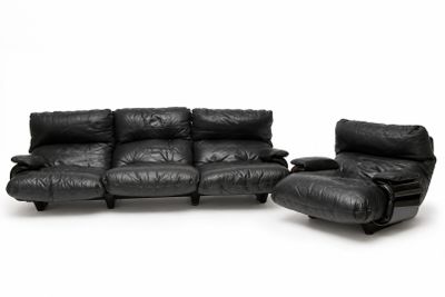 black leather sofa and recliner set on a white background