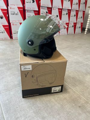 a green helmet on top of a box on the floor
