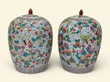 two vases sitting side by side on a white surface
