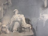 a picture of a woman sitting in a chair with a dog