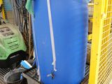 a blue barrel sitting on top of a metal cart