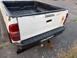 a white pick up truck parked on the side of the road